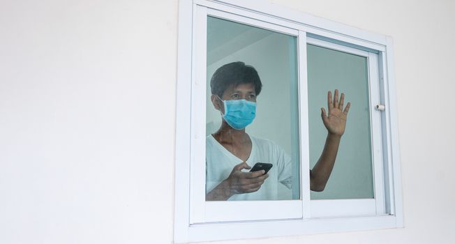 Man in isolation at home for coronavirus outbreak (COVID-19), Quarantine to prevent the spread of the coronavirus (COVID-19)