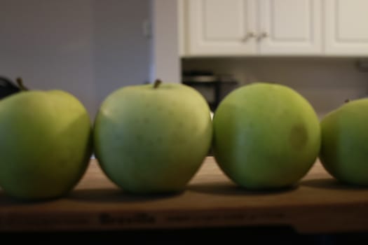 green apples in a row. good concept photo.