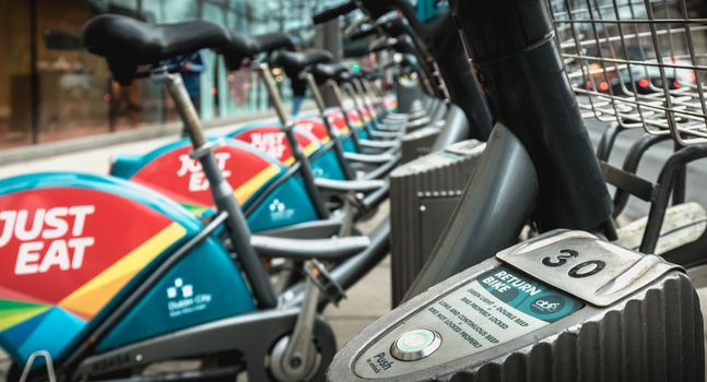 Dublin, Ireland - February 11, 2019: Detail of a shared public bike station Just Eat dublinbikes in the city center on a winter day