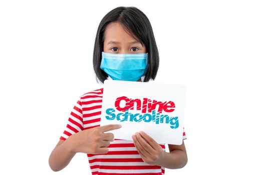 Coronaryvirus and Education Concepts, The girl wearing a mask holding a paper with a message "Online Schooling" To encourage everyone to work together to teach children at home.