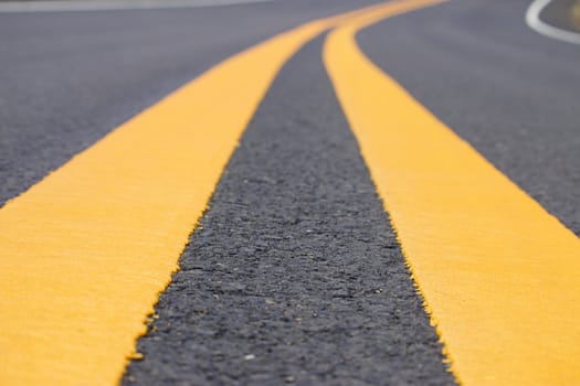 Yellow curved traffic line on the highway, Close up