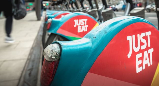 Dublin, Ireland - February 11, 2019: Detail of a shared public bike station Just Eat dublinbikes in the city center on a winter day