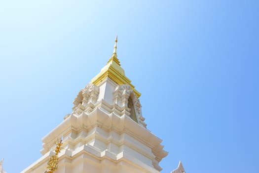 Religious architecture and beliefs, a beautiful white Thai temple on a blue sky
