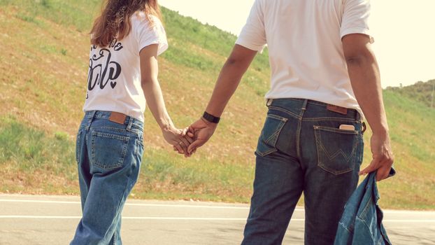 Couples walk and hold hands while traveling
