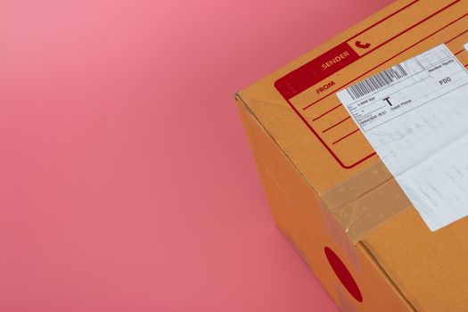 Parcel boxes are shipped by shipping companies on a bright pink background.