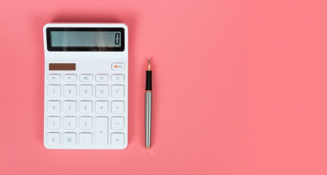 White calculator and pen on a bright pink background, marketing and financial concepts