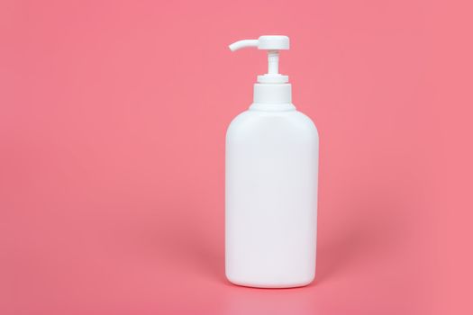 Cosmetic mock up bottle on pastel pink background