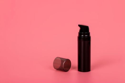 Cosmetic mock up bottle on pastel pink background