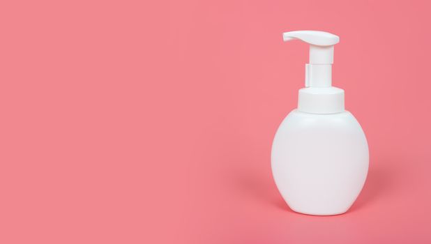 Cosmetic mock up bottle on pastel pink background