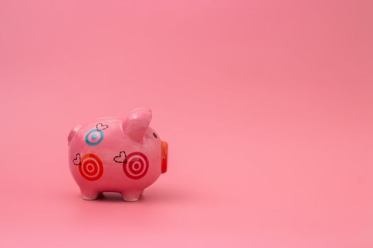 Pink piggy bank on pastel pink background, Financial concepts