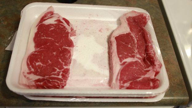 Fresh sirloin beef steak in packaging tray
