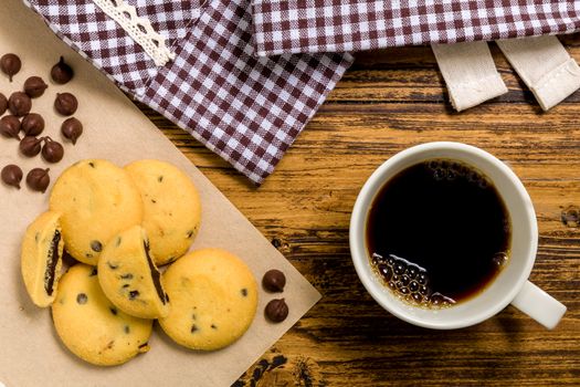 Chocolate lava cookies with coffee on wooden background.