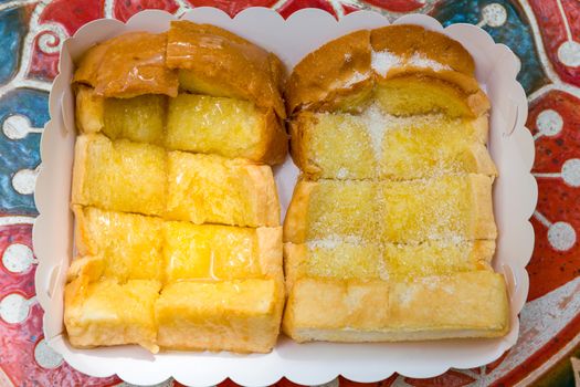 Toasted bread with sugar and butter spread as dessert.