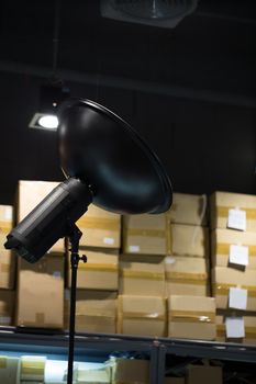Studio strobe light with background of busy photography studio.