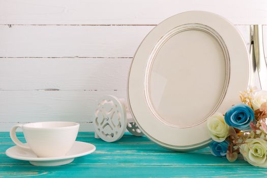 White vintage photo frame on table with decoration background.