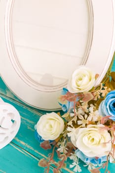 White vintage photo frame on table with decoration background.