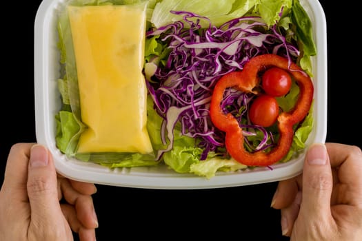 Fresh salad in plastic box ready for takeaway.