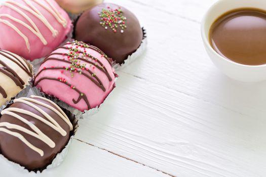 Colorful donuts with cup of coffee for relaxing moment.