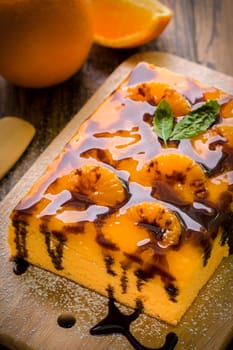 Orange cake with chocolate sauce for tea break.