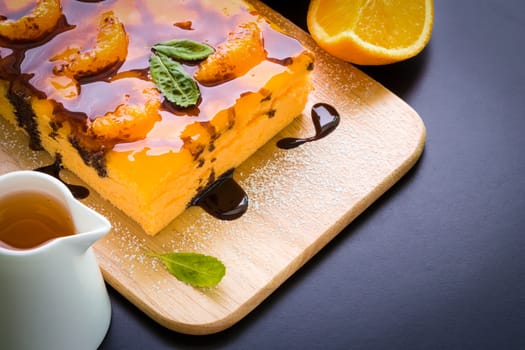 Orange cake with chocolate sauce for tea break.