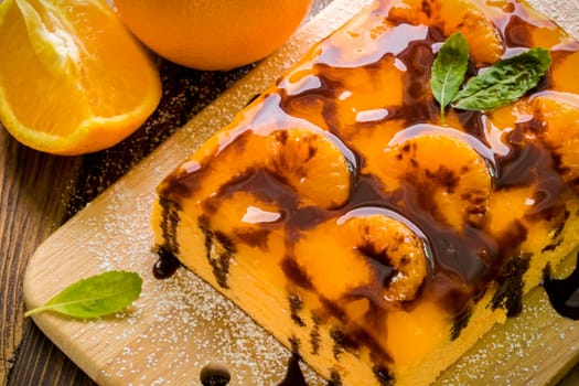 Orange cake with chocolate sauce for tea break.