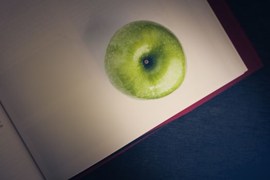 Green apple with book illustrated knowledge and wisdom concept.