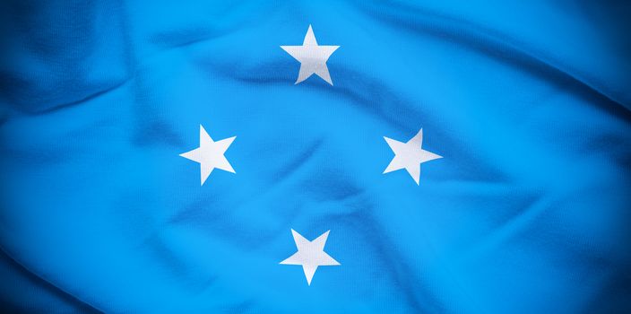 Wavy and rippled national flag of Micronesia background.