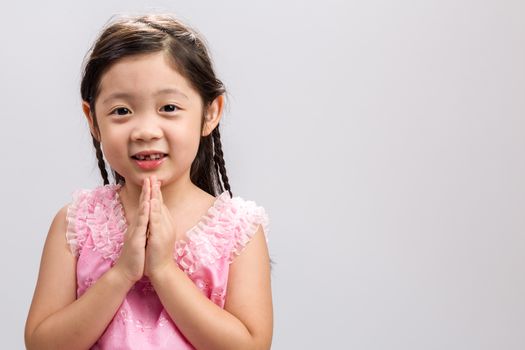 Thai child in traditional Thai costume on white background.