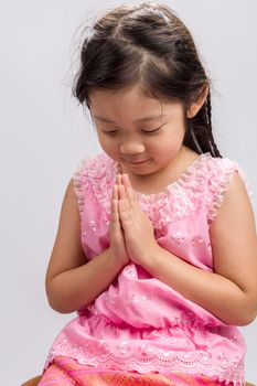 Thai child in traditional Thai costume on white background.