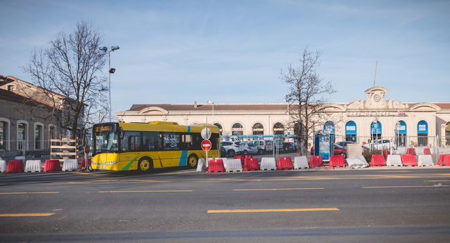 Sete, France - January 4, 2019: Bus and car traffic in front of the SNCF train station in the city center on a winter day