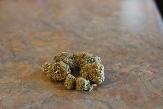 group of marijuana buds on a table top.