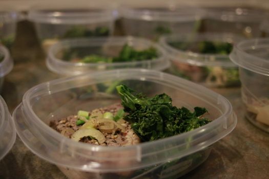Healthy meal prep containers with quinoa, chicken and cole slaw.