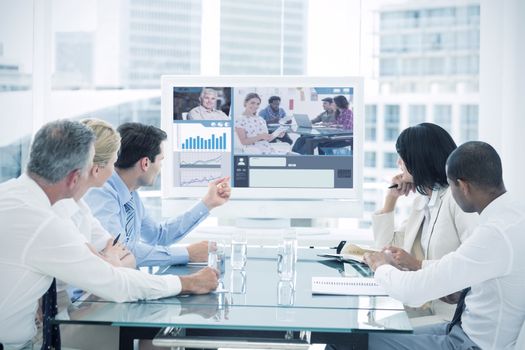 Editor holding tablet and smiling as team works behind her against business people looking at blank whiteboard in conference room