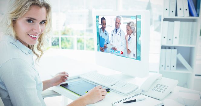 View of video chat app against portrait of a smiling young woman using computer