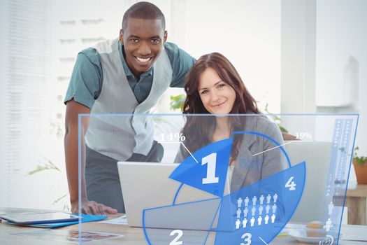 Futuristic interface pie chart interface  against portrait of smiling businesswoman working on laptop with coworker at desk 