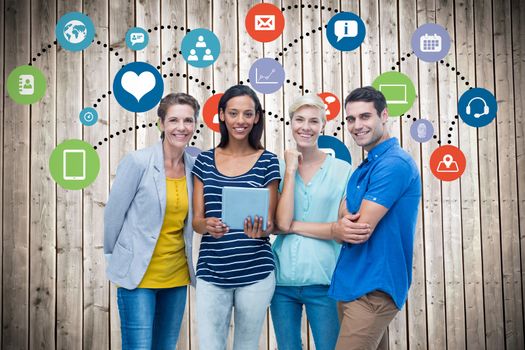 Group portrait of happy colleagues using tablet against wooden planks background