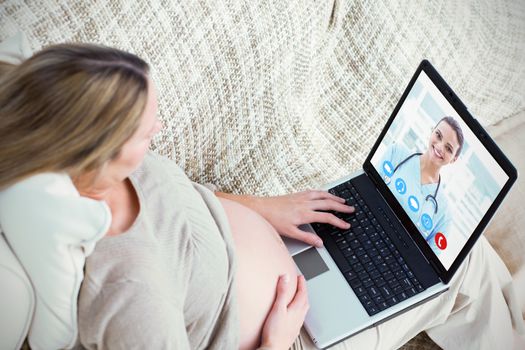 View of video chat app against top view of a future mom using her laptop on the sofa 