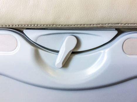 Food tray and drink rack rear passenger seat on airplane.