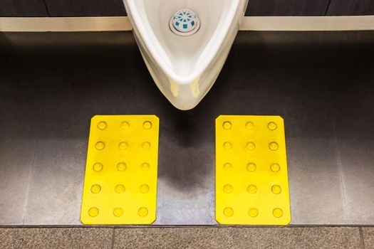 White ceramic urinals in men's bathroom design for the visually impaired. Japan