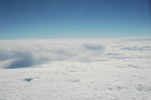 Aerial view of Clouds through flight window