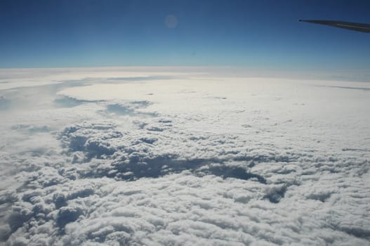 Aerial view of Clouds through flight window