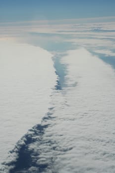 Aerial view of Clouds through flight window