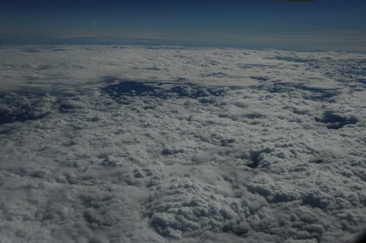 Aerial view of Clouds through flight window