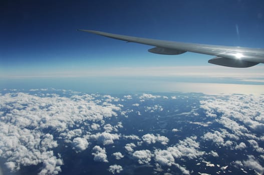 Aerial view of Clouds through flight window
