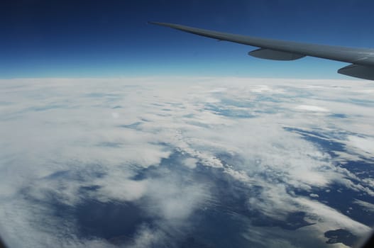 Aerial view of Clouds through flight window