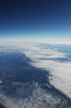 Aerial view of Clouds through flight window