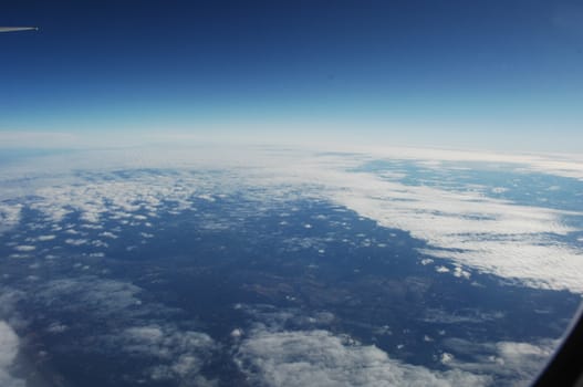 Aerial view of Clouds through flight window