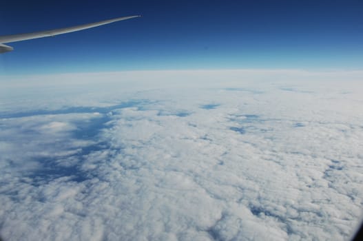 Aerial view of Clouds through flight window