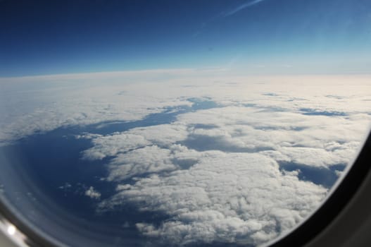 Aerial view of Clouds through flight window
