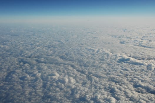 Aerial view of Clouds through flight window